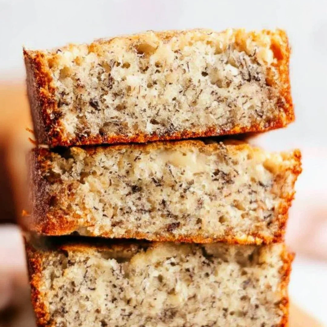 Slice of delicious homemade banana bread on a wooden cutting board