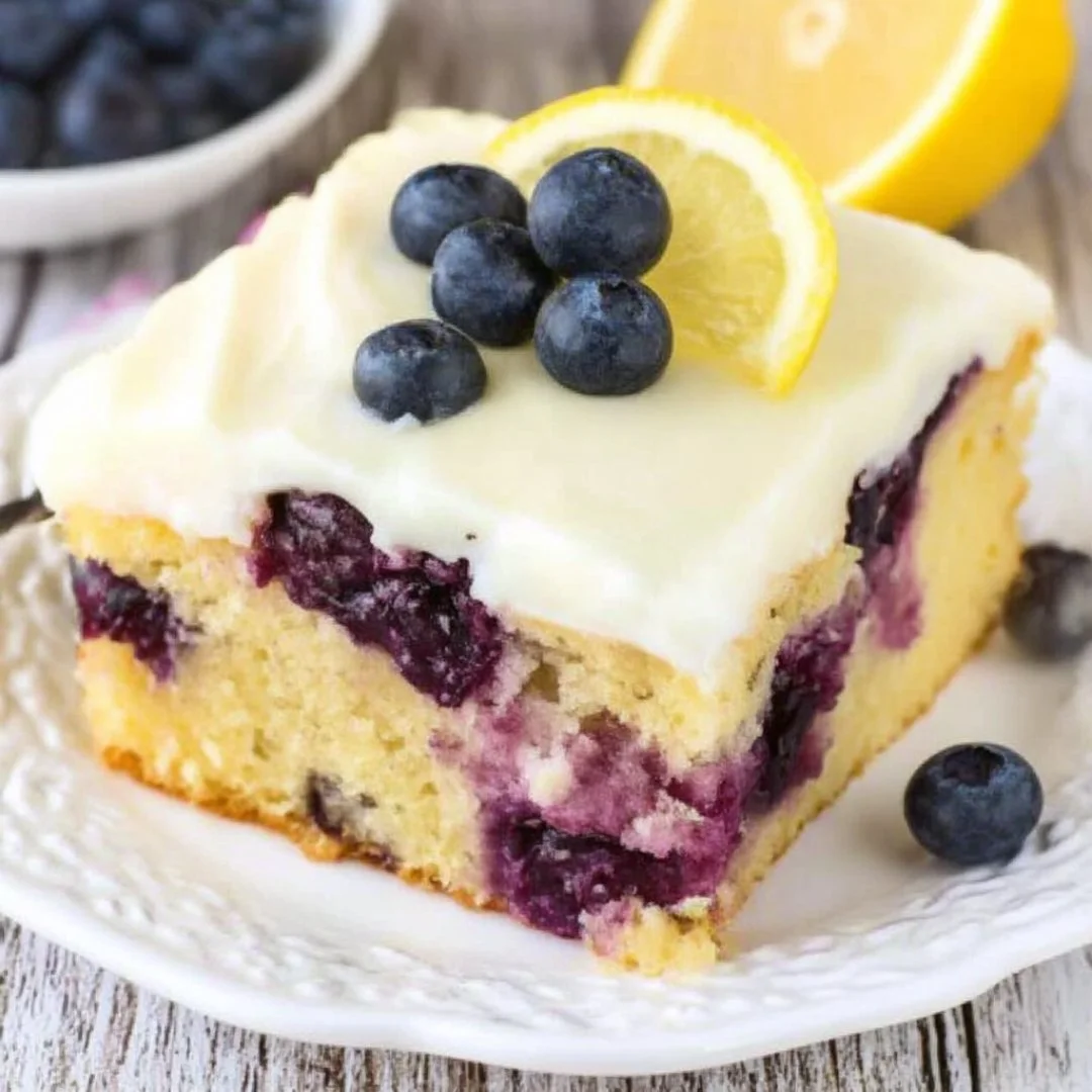 Delicious Lemon Blueberry Cake garnished with fresh blueberries and lemon zest