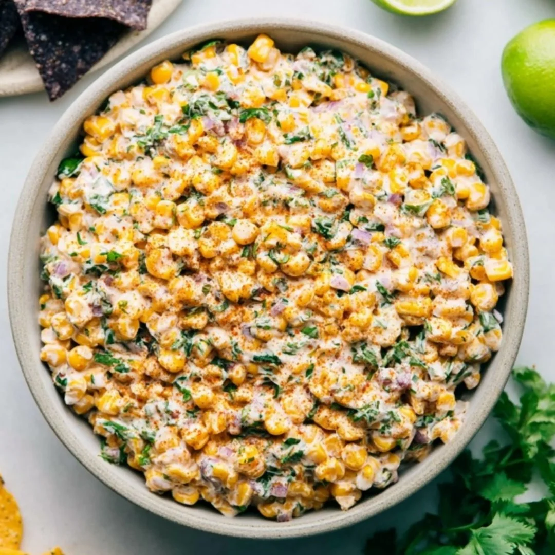 Bowl of Mexican street corn dip topped with cheese and cilantro