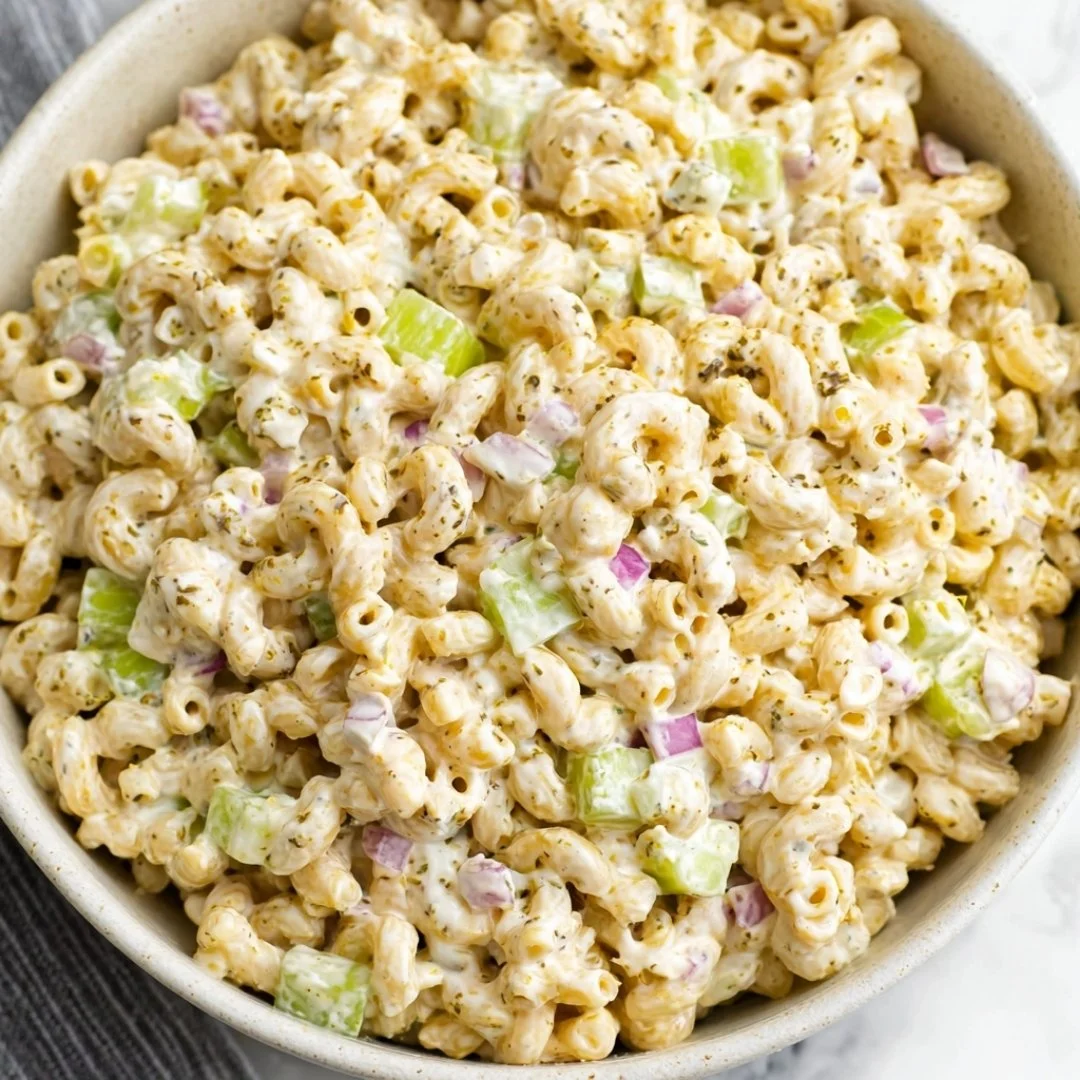 Bowl of old-fashioned creamy macaroni salad with vegetables and dressing