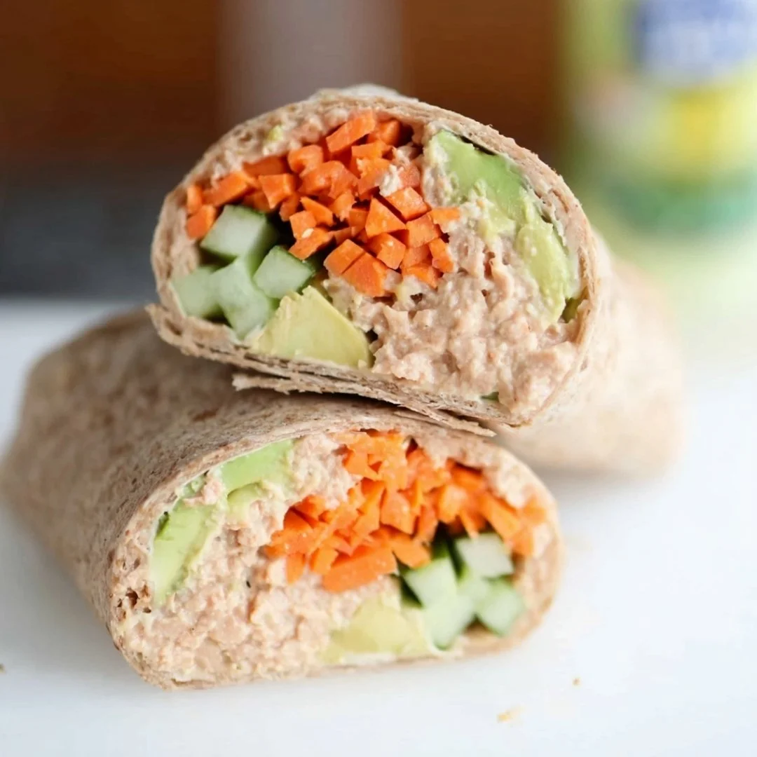 A bright, fizzy blue beverage with granulated salt crystals and a clear jar on a granite surface.
